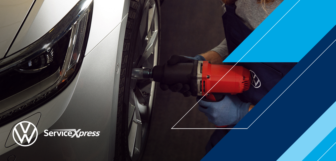 Technician Servicing tires at VW service center