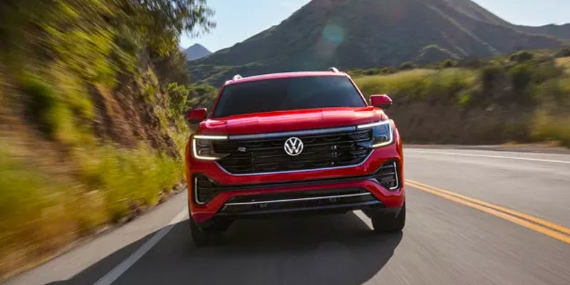Red Volkswagen Atlas in motion on the road